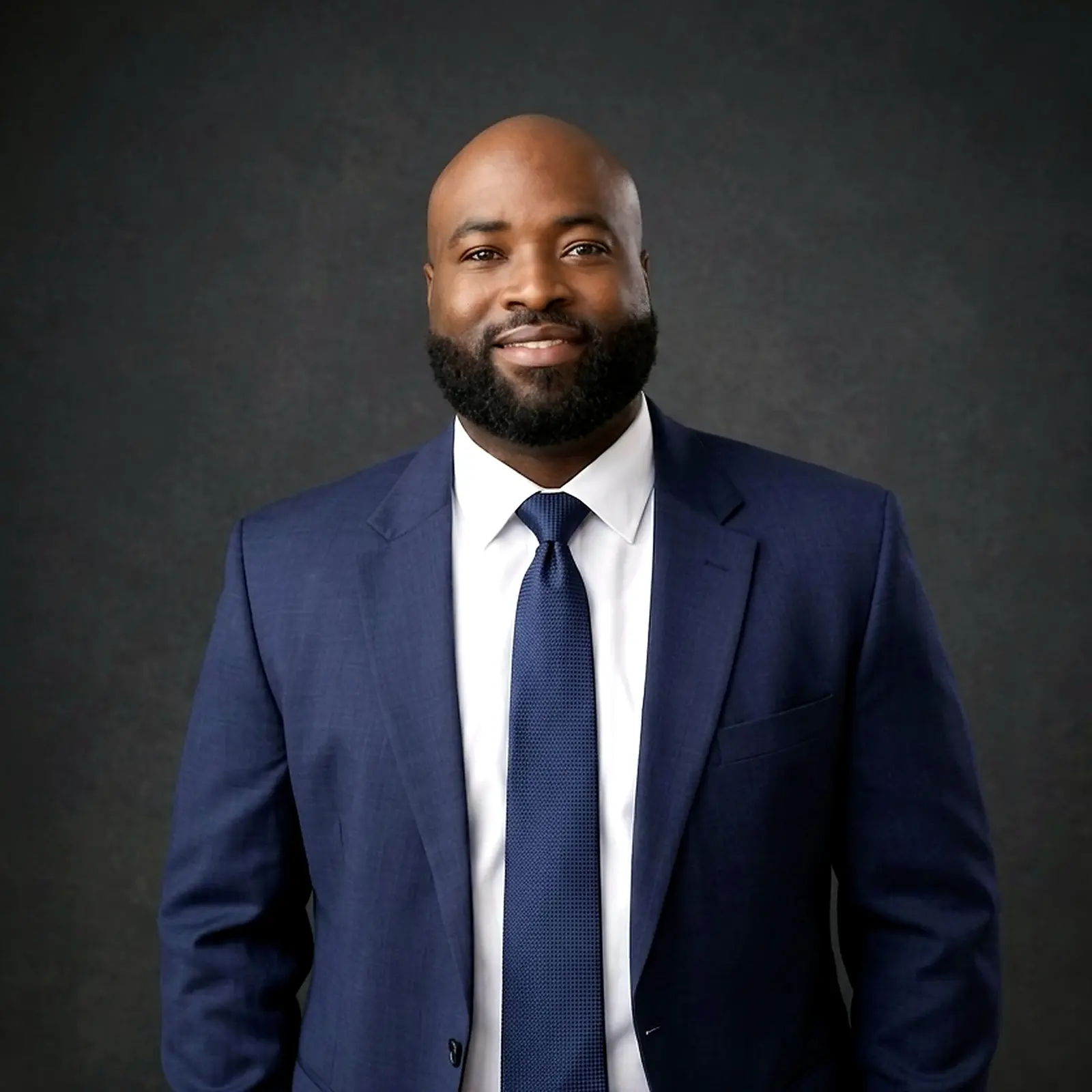 Emmanuel S. Desmolieres in a navy blue suit
